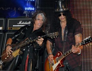 Joe Perry (L) and guitarist Slash perform during a concert at the Bare Pool Lounge at The Mirage Hotel & Casino to celebrate the resort's 20th anniversary early on October 3, 2009 in Las Vegas, Nevada.