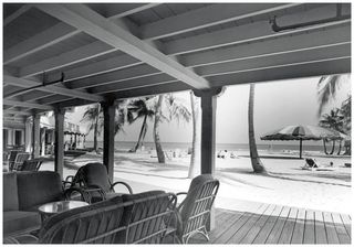 Covered lounge area with decking, looking out to the beach