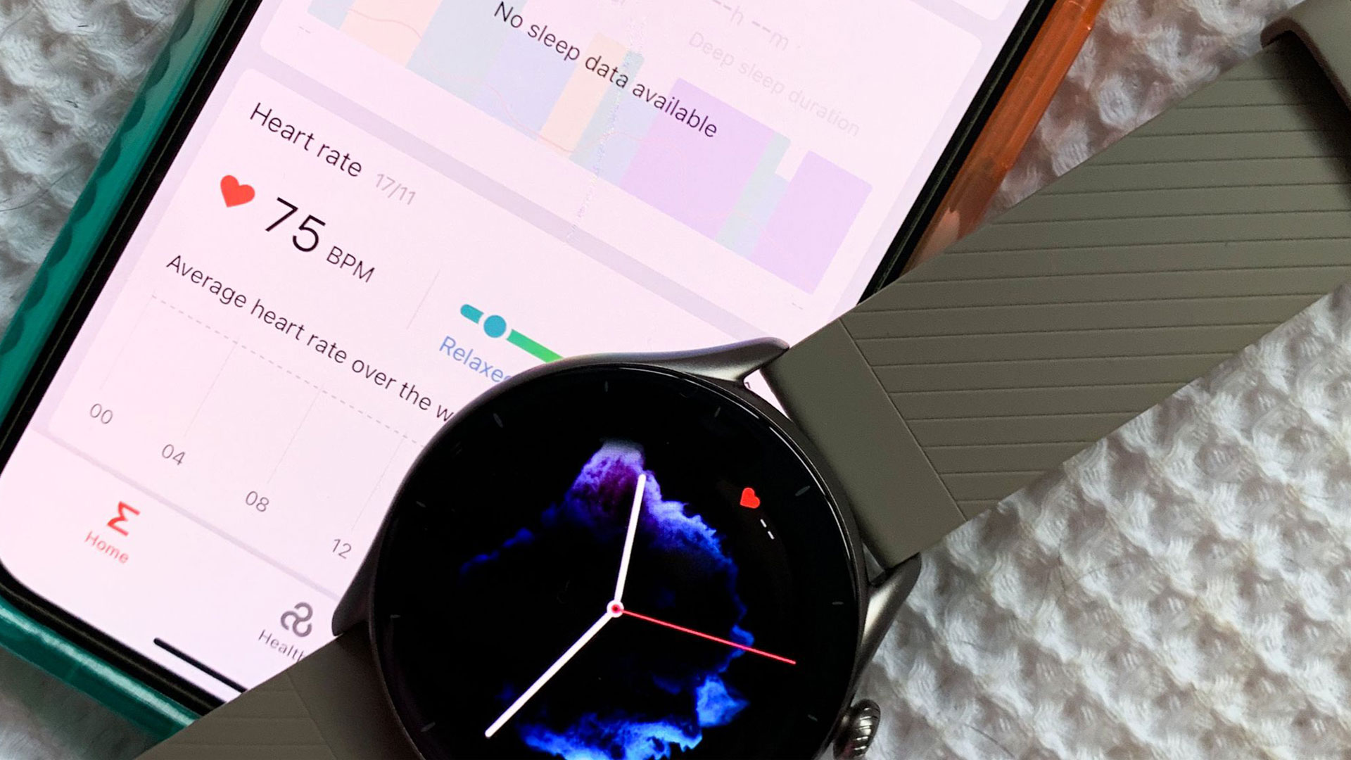 Image shows the Amazfit GTR 3 next to a phone screen showing heart rate and health metrics.