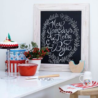 welcome chalkboard with whitewashed wooden frame against white wall