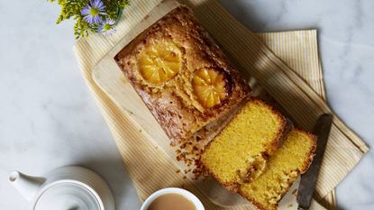 Gluten free lemon and clementine cake on a board with english breakfast tea