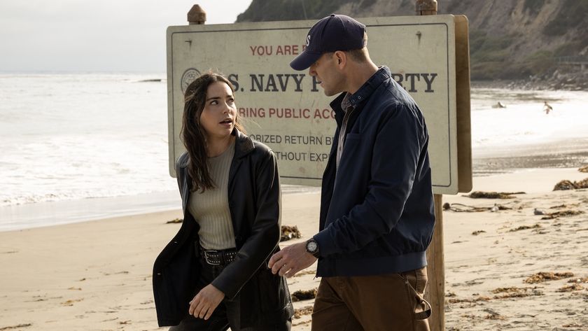 Gibbs and Lala walking across Navy section of a beach in NCIS: Origins