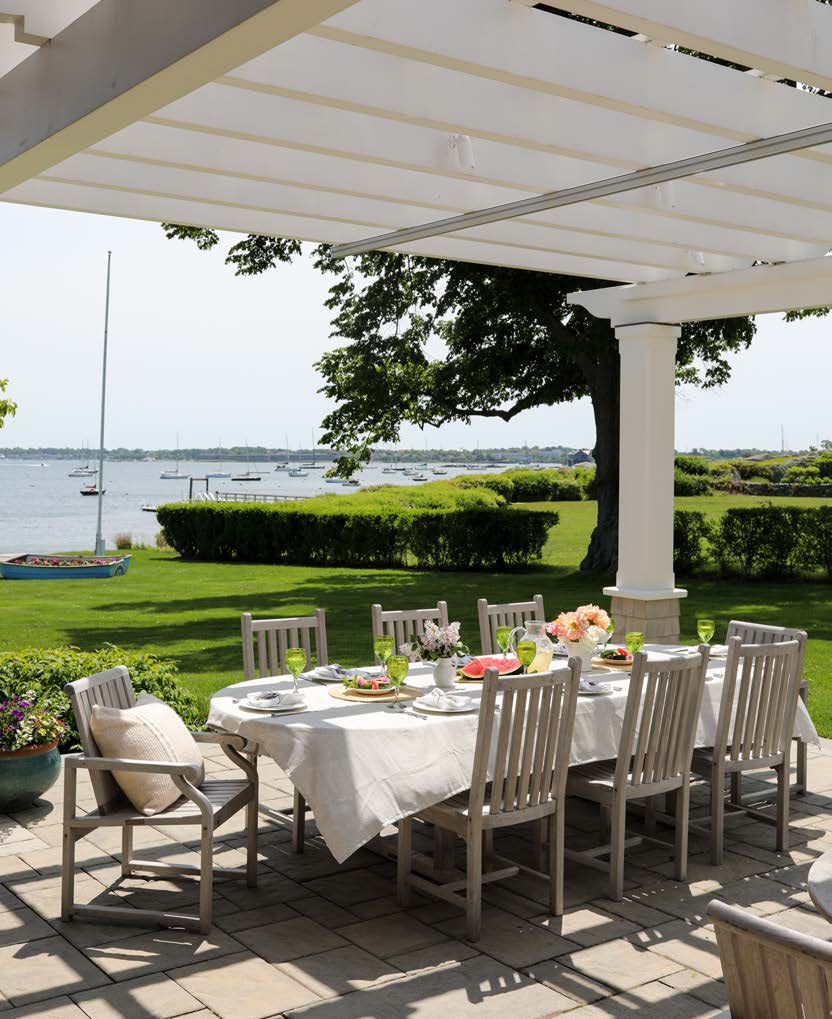 seaside outdoor dining area under a pergola