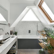 bathroom with tiles on wall and bathtub and sink