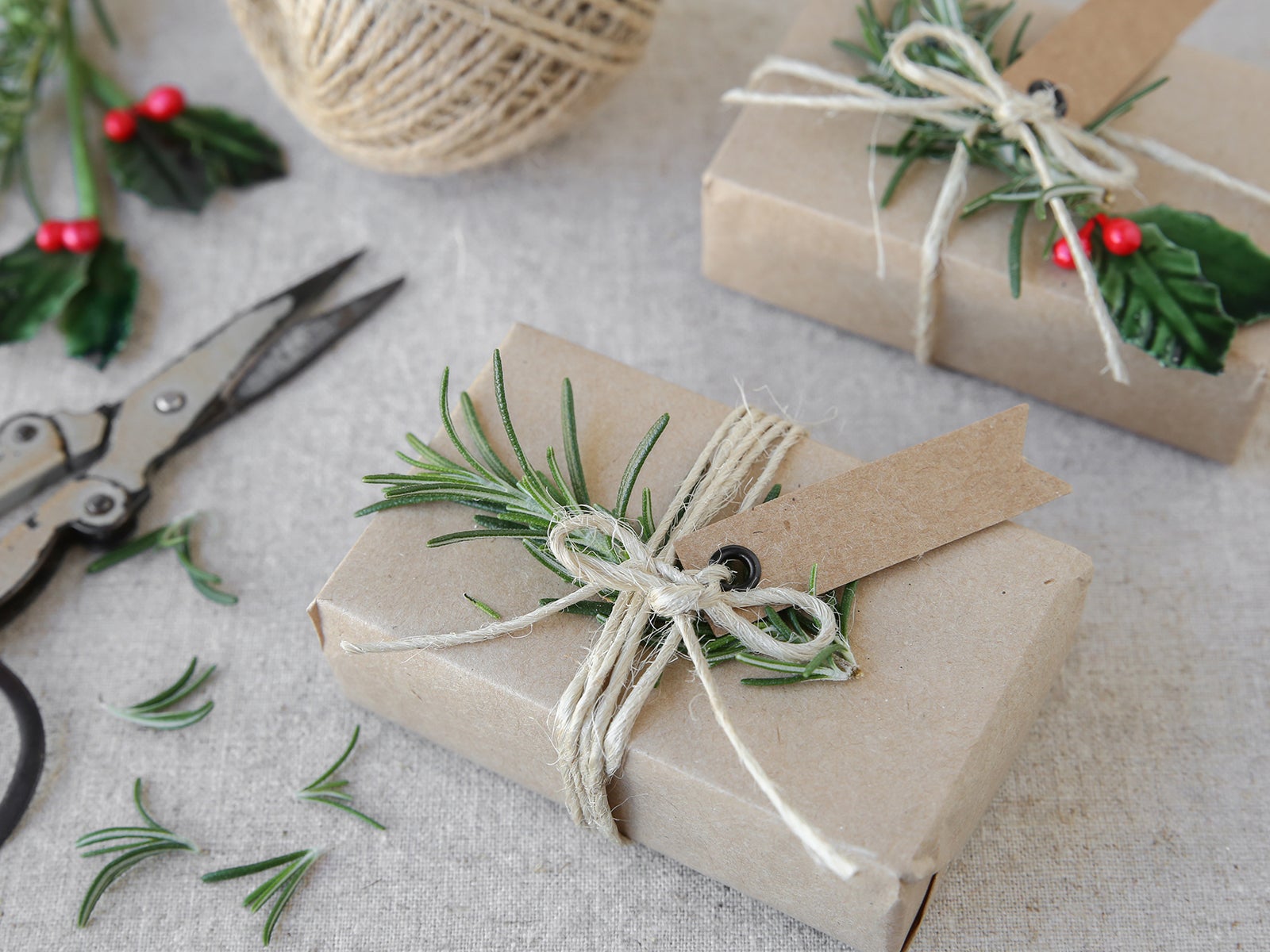 Eco craft Christmas gift boxes wrapped in string and trimmed with rosemary