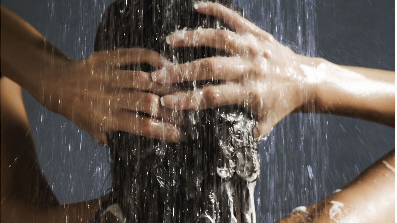 Woman washing her hair in shower