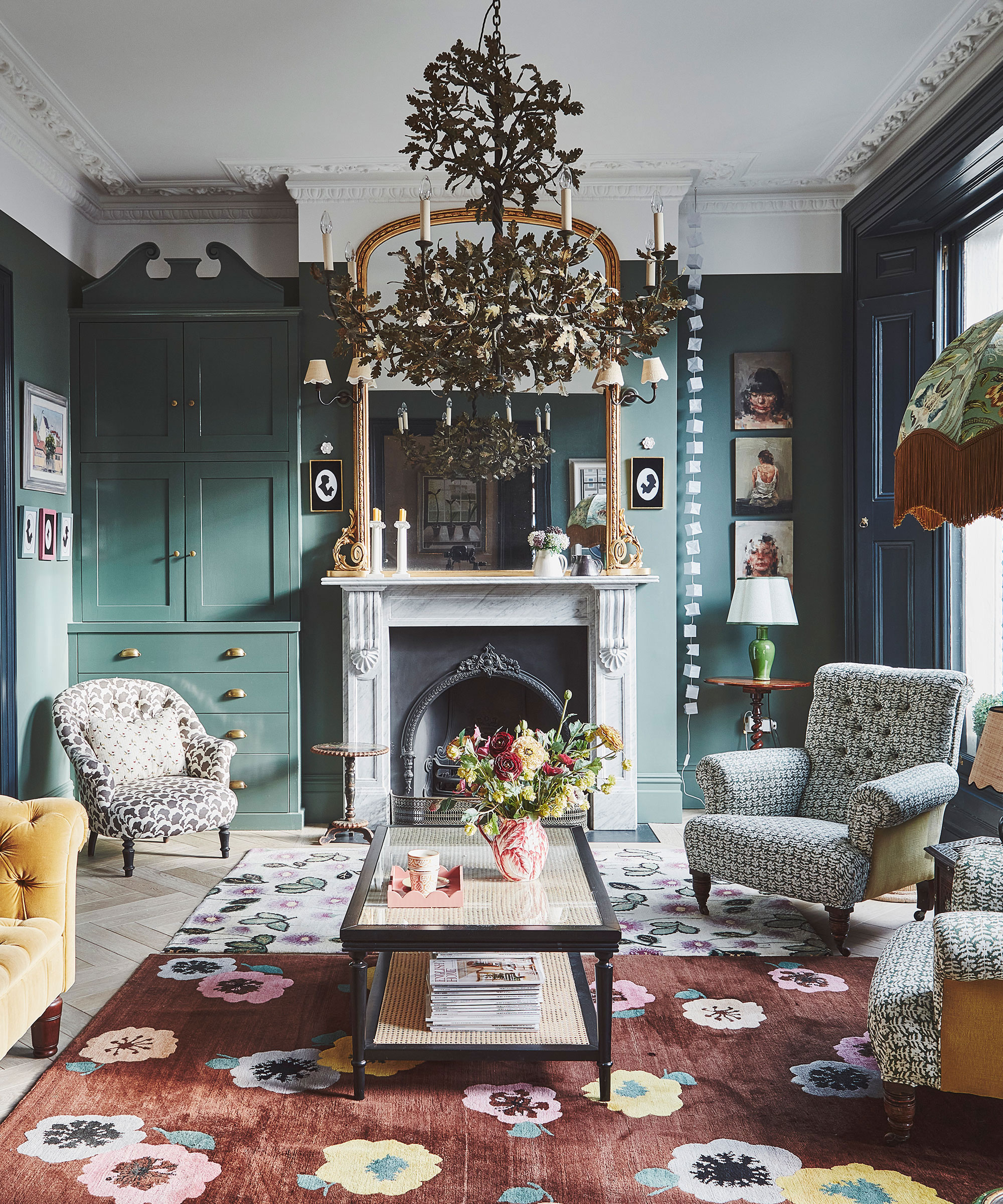 grand country house style living room with teal walls and statement chandelier
