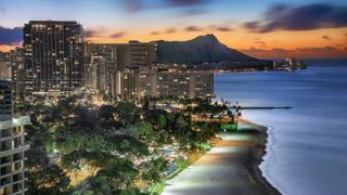 Oahu's buildings and volcano pictured at night