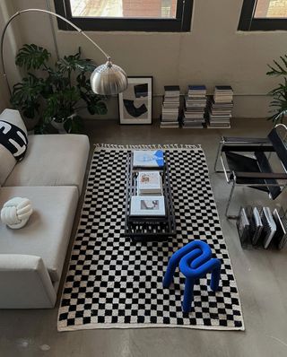 Black and white themed living room with a blue accent chair