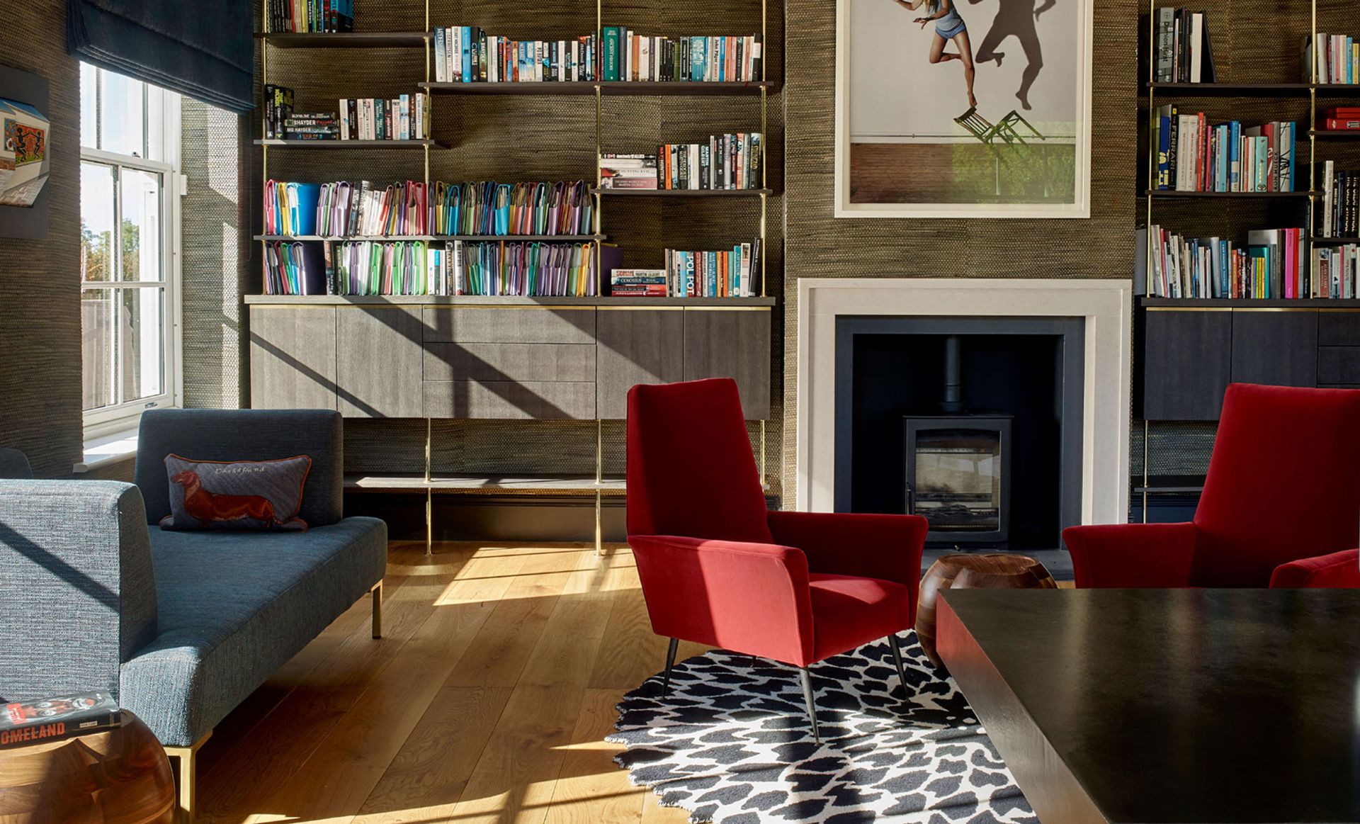 Living room with sofa and armchairs, wood floor and rug