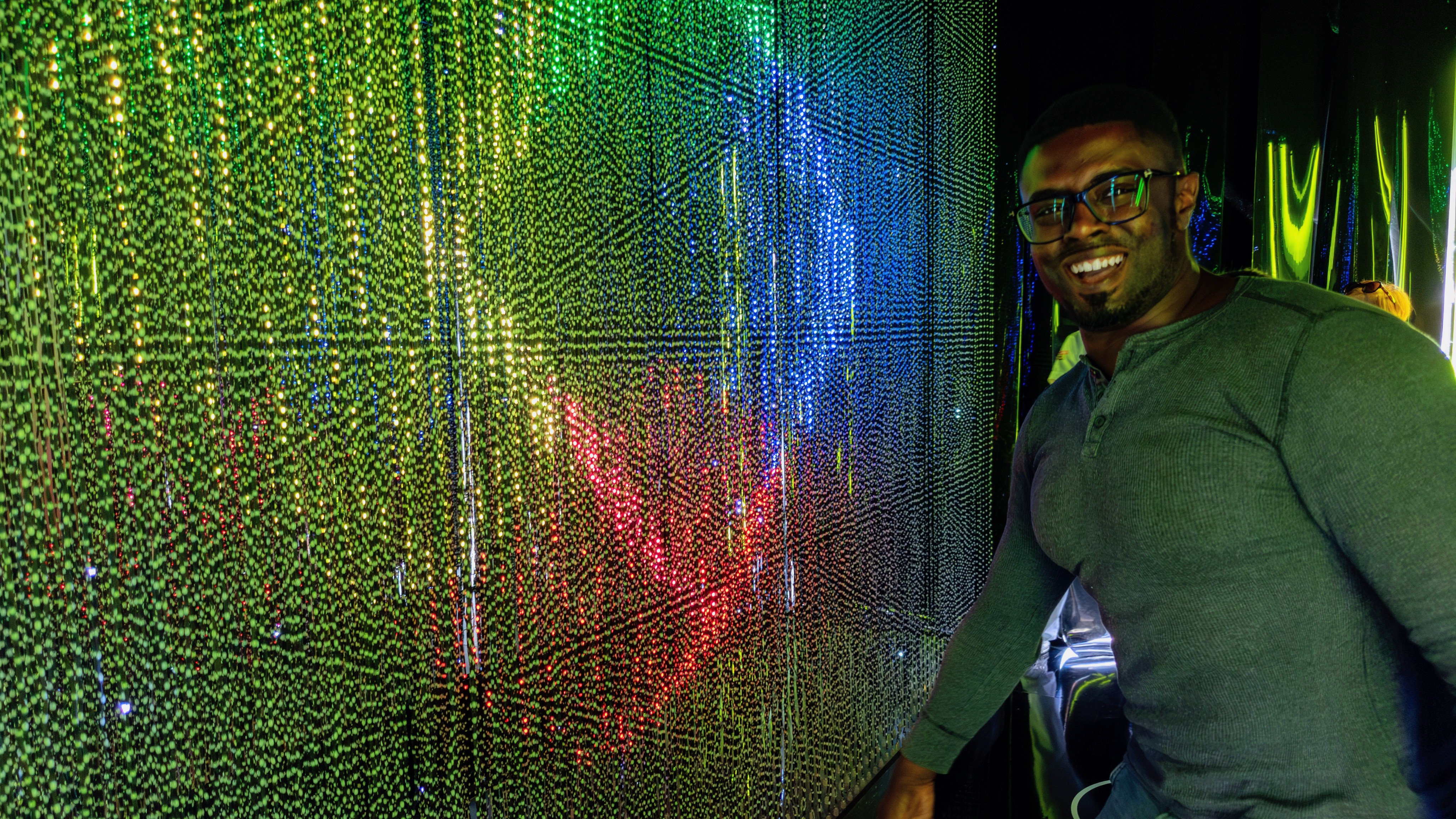 Derrek in front of light display