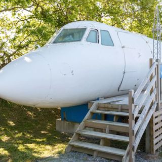 garden with white aeroplane and wooden stairs