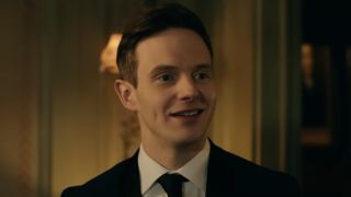 Mark O'Brien as Alex in a suit smiling in Ready or Not