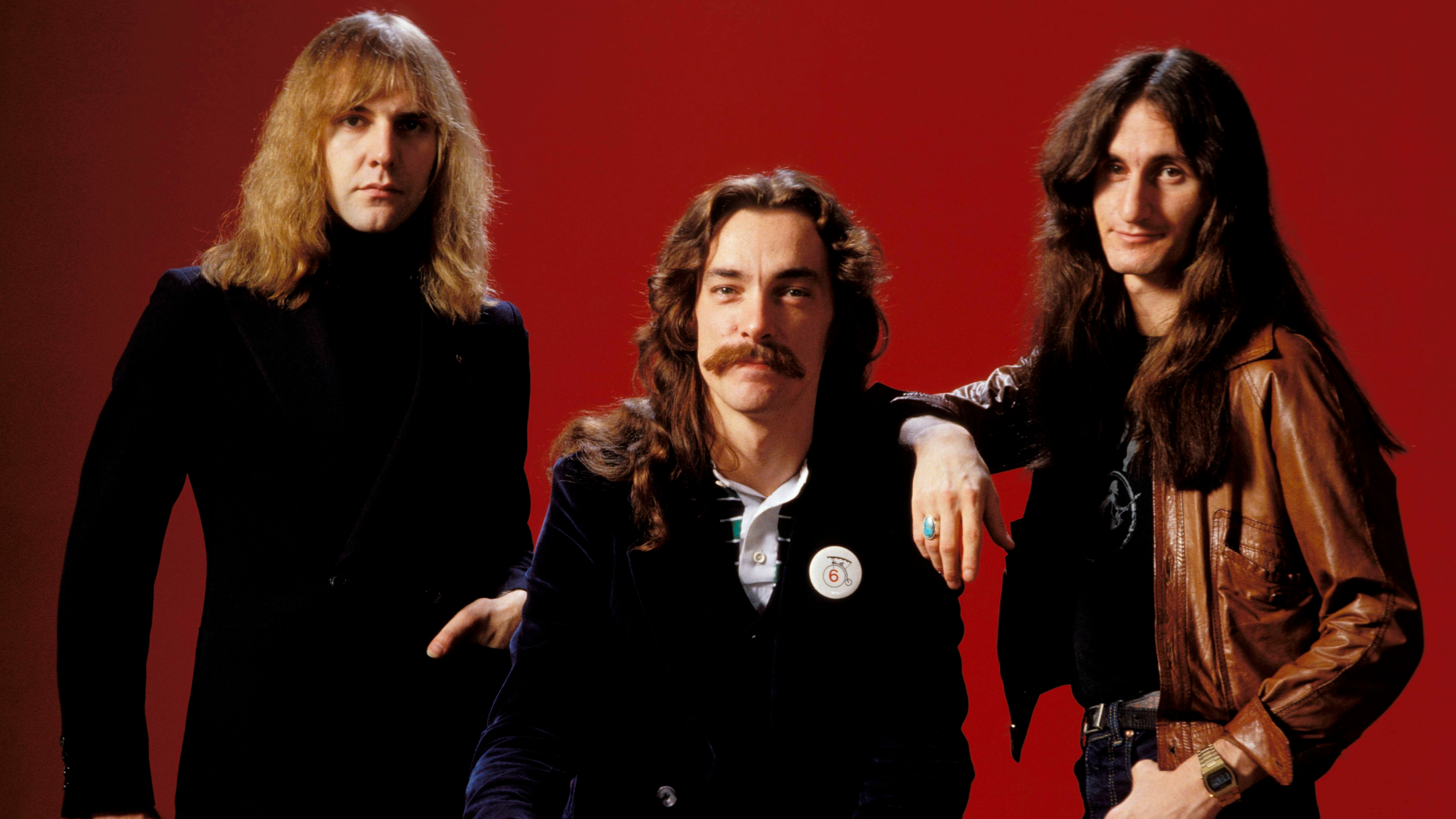 Photo of Neil PEART and RUSH and Alex LIFESON and Geddy LEE; L-R: Alex Lifeson, Neil Peart, Geddy Lee - posed, studio, group shot,