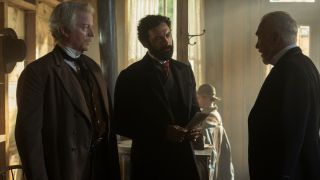 Morgan Spector stands stoically while talking to Patrick Page as CJ Wilson watches in The Gilded Age S3 E1 - "Who Is In Charge Here>"