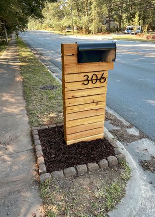 Wooden mailbox landscaping ideas on a front walkway.