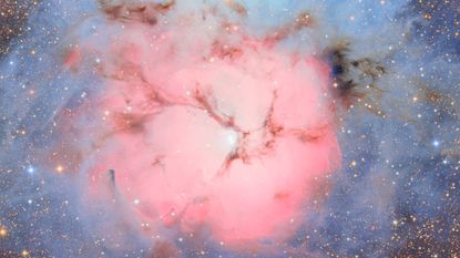 an image of a nebula with a round pink cloud in the middle and blue clouds on the outer edges
