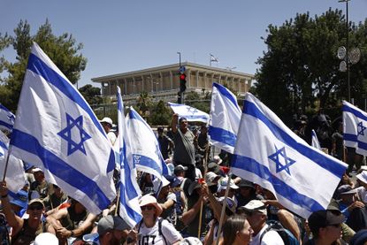 Protesters in Israel waving Israeli flags