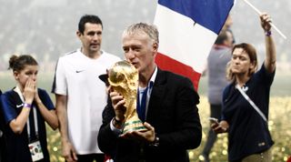 France manager Didier Deschamps carries the World Cup trophy after the Russia 2018 World Cup final football match between France and Croatia at the Luzhniki Stadium in Moscow on July 15, 2018.