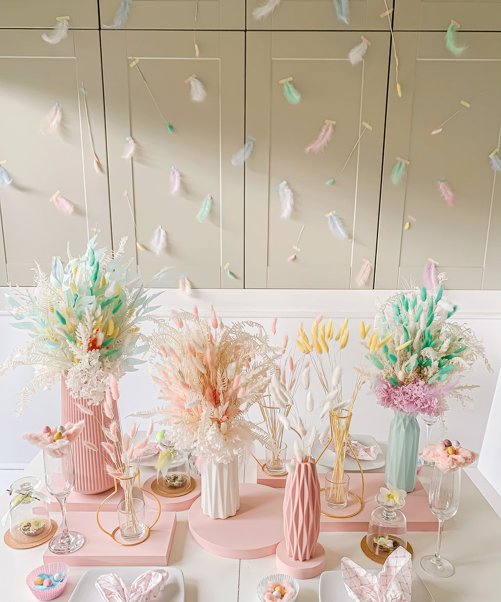 Pretty seasonal tablescape in pastel palette, with feather and washi tape backdrop.