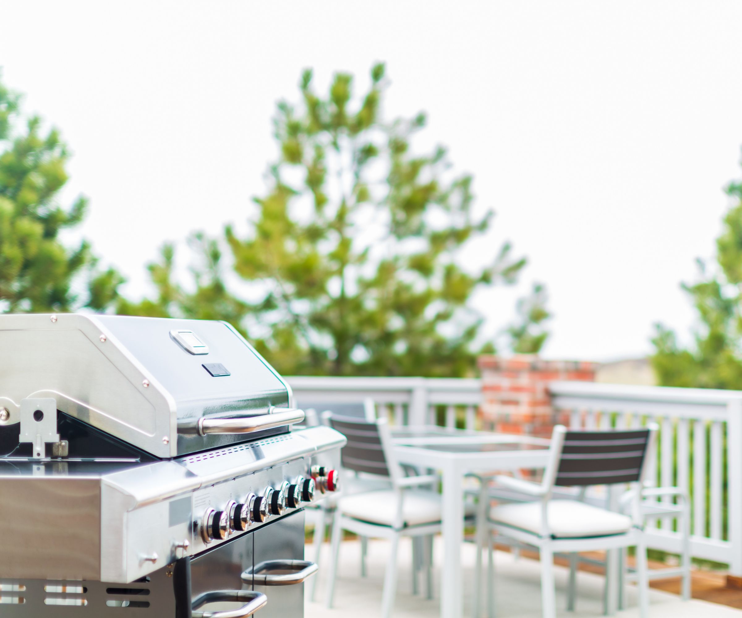 A gas grill on a deck