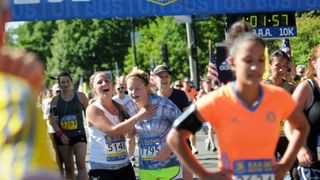 Runners cross the finish line at the B.A.A 10K. Sunday, June 22, 2014