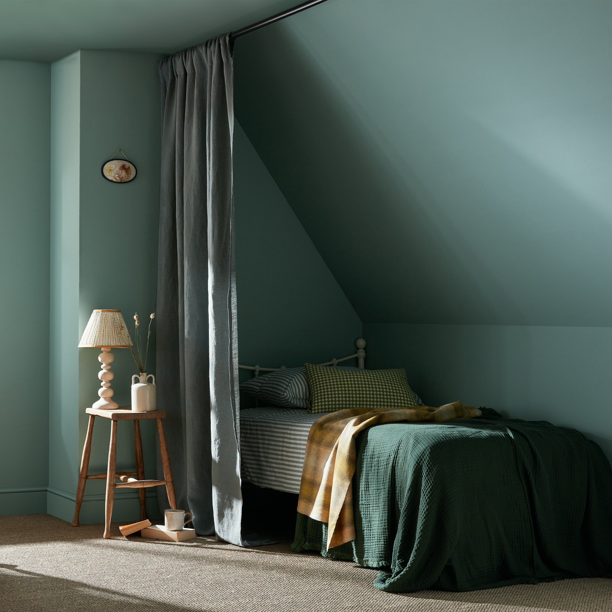 A bedroom painted in Earthborn's pale turquoise 'Splashing' Claypaint