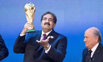 The Emir of Qatar accepts the World Cup trophy on behalf of the tiny country, which will be host to the 2022 international soccer games.