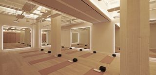Workout room at Bian spa in Chicago with beige wall and pink workout mats