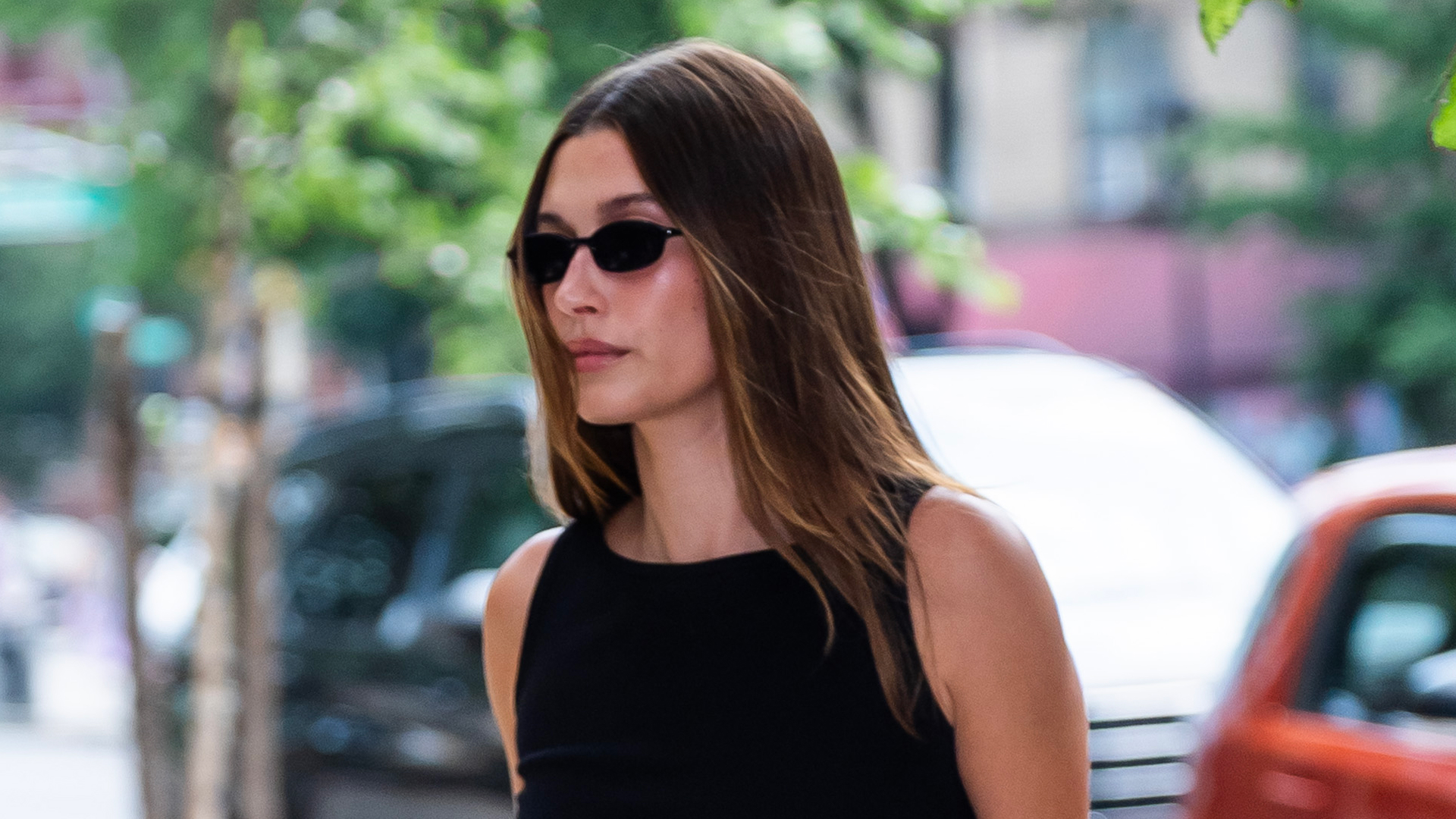 Hailey Bieber walking in Manhattan wearing polka dot leggings and a baby bag