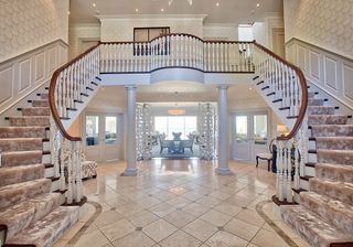 hallway with double staircase and tiles flooring