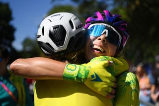 Georgia Baker gets a hug after winning the women's Commonwealth Games road race