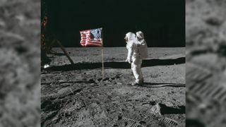 Astronaut Edwin E. Aldrin Jr., lunar module pilot of the first lunar landing mission, poses for a photograph beside the deployed United States flag during Apollo 11 extravehicular activity (EVA) on the lunar surface.