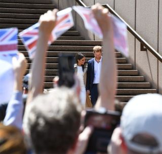 Prince Harry and Meghan, the Duchess of Sussex, leaving the Sydney Opera House, which they visited as part of a 16-day tour to Australia, Fiji, Tonga, and New Zealand, October 2018.