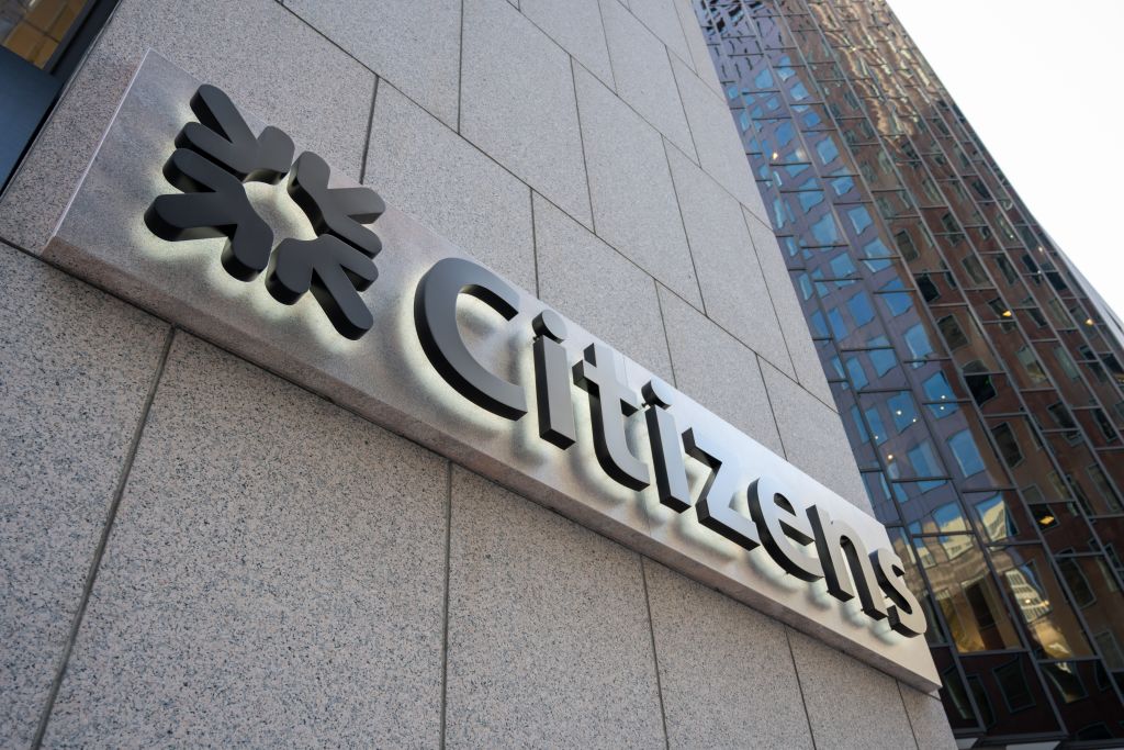 Close-up of Citizens Bank sign on a granite building facade with reflective glass architecture, Embarcadero area, San Francisco, California, February 21, 2025.