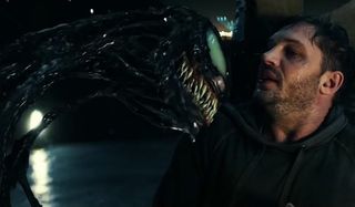 Venom threatens Eddie on a dimly lit rooftop