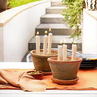 garden party with terracotta plant pots and candles