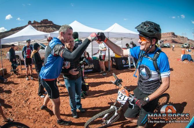 A rider is congratulated after the finish