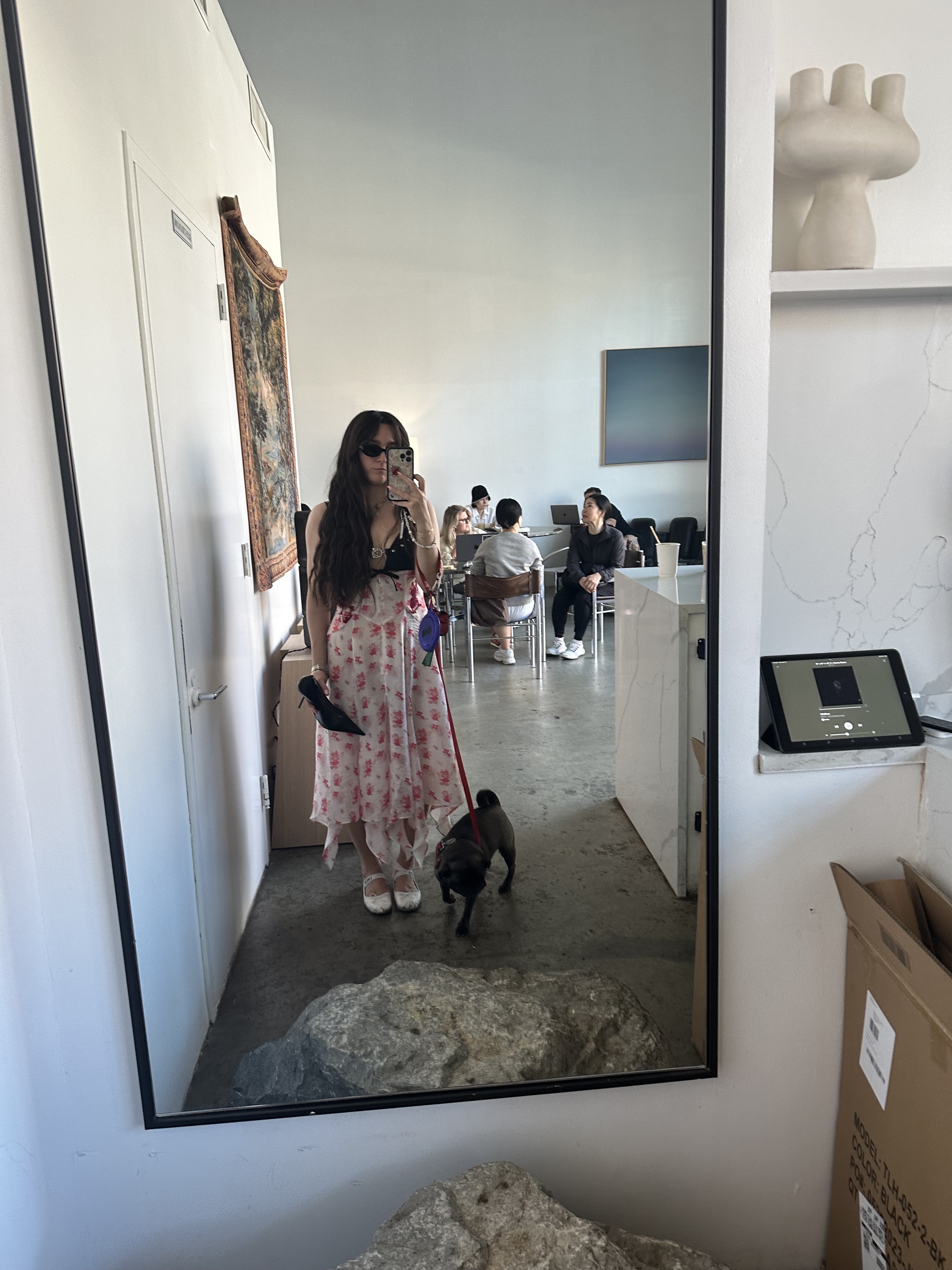 Selfie of a fashion editor holding a heel pump