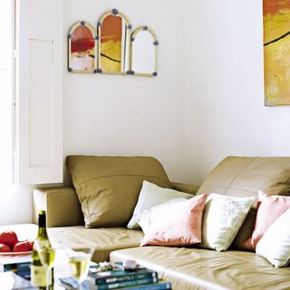 living room with l shaped sofa white wall and cushions