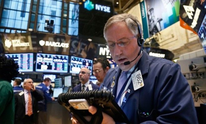 A trader monitors activity from his mobile workstation at the New York Stock Exchange on Feb. 20.