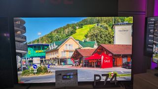 TCL 98P745 with demo footage of bright houses on screen