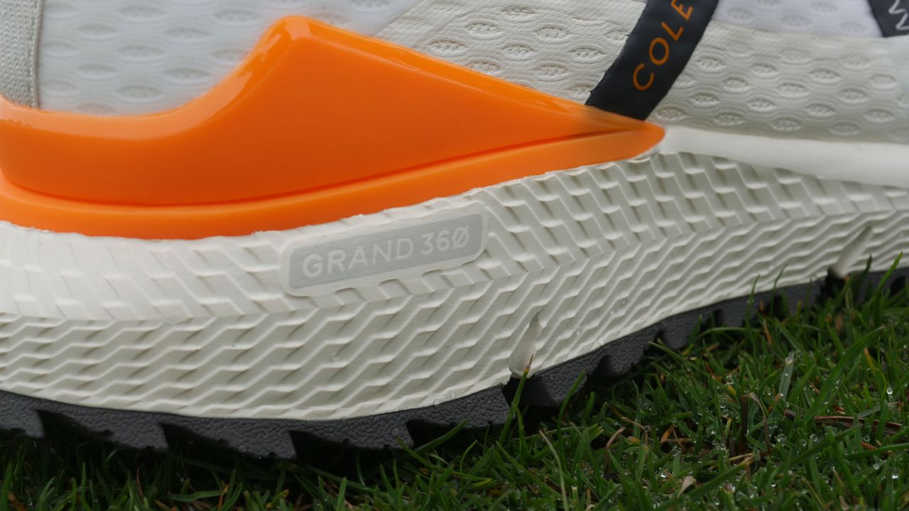 The bright orange TPU heel cup on the Cole Haan ZeroGrand Overtake golf shoe