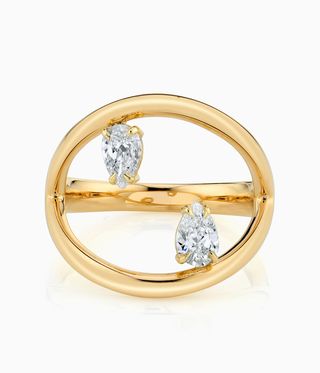 Anita Ko's engagement ring with gold band a inverse diamonds at top and bototm.