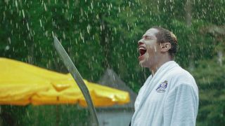 Pete Davidson holding a sword in the rain in Bodies Bodies Bodies