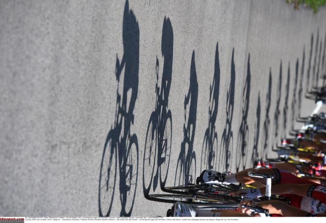 The riders cast their shadows on the road