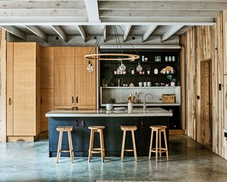 Rustic kitchen in lighting designer Tom Raffield's Cornish timber home