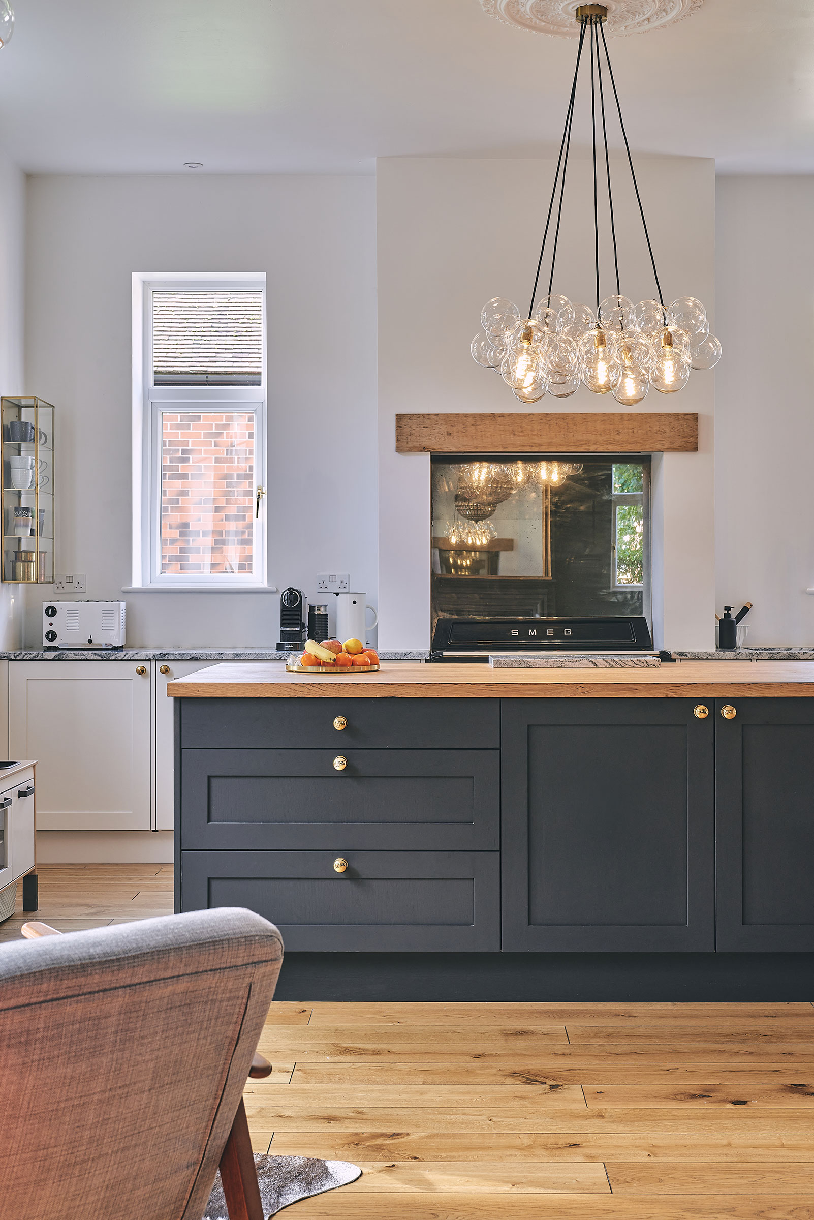 kitchen with double sided fireplace with range cooker and large kitchen island