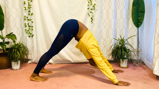 Personal trainer Elethia Gay performs downward dog