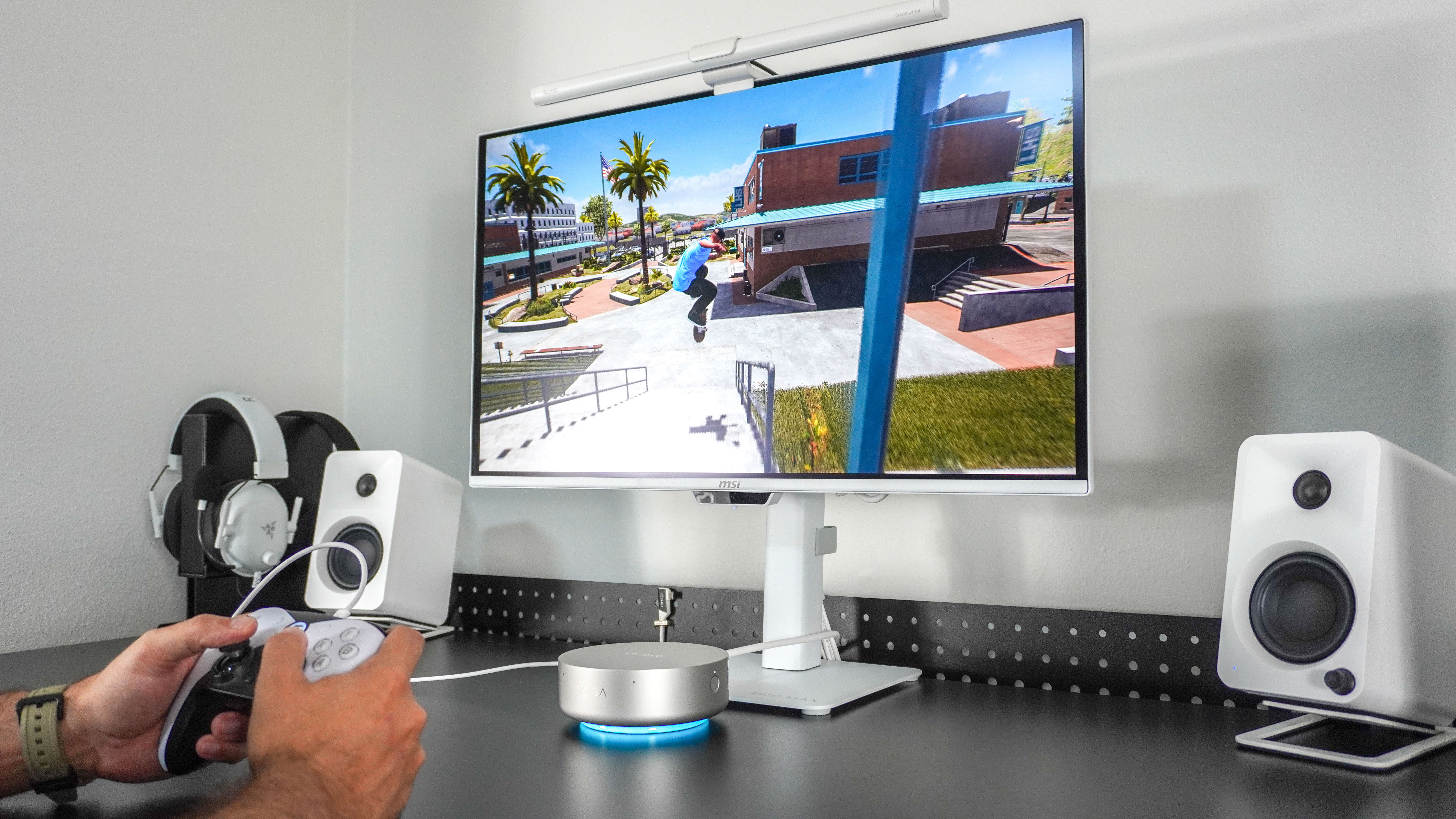 A person playing games with a controller on the Lenovo Yoga Mini mini PC